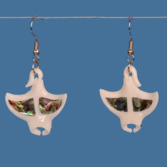 Pair of earrings with a manta ray design and paua center on a blue background