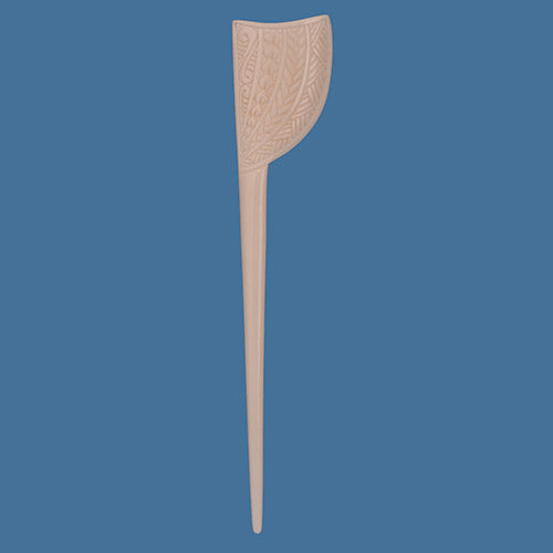 Bone Hair Pin with decorative patterns on a blue background