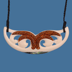 Decorative necklace with a white pendant and brown stained design on a blue background