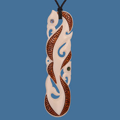 Decorative pendant with intricate designs on a blue background