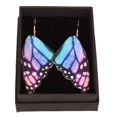 Butterfly wing earrings with blue, purple, and pink colors on a white background