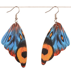 Butterfly wing earrings with blue, yellow, and black design on a white background