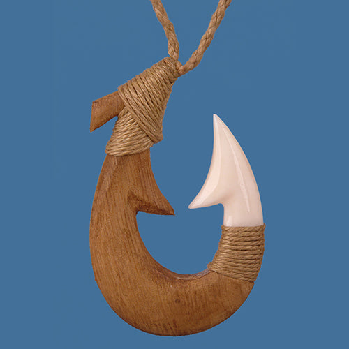 Wooden fish hook pendant with a white tip on a blue background