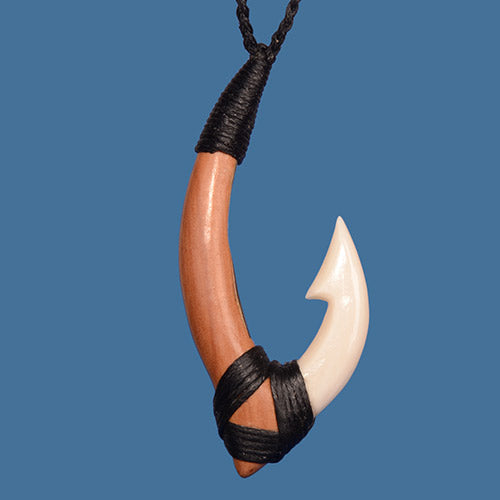 Hook pendant with black cord on a blue background