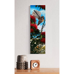 Painting of a bird perched on a branch with red flowers and a blue sky.