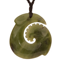 Green jade pendant with spiral design on a white background