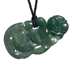 Green jade tiki pendant on a black cord against a white background