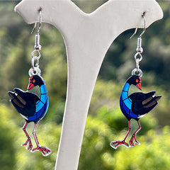 Pukeko on a white stand with a blurred green background