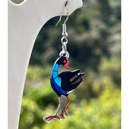 Pukeko on a white stand with a blurred green background