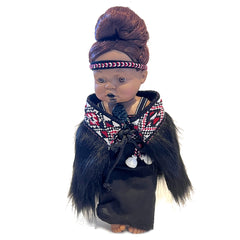 Doll with traditional attire and headband on a white background