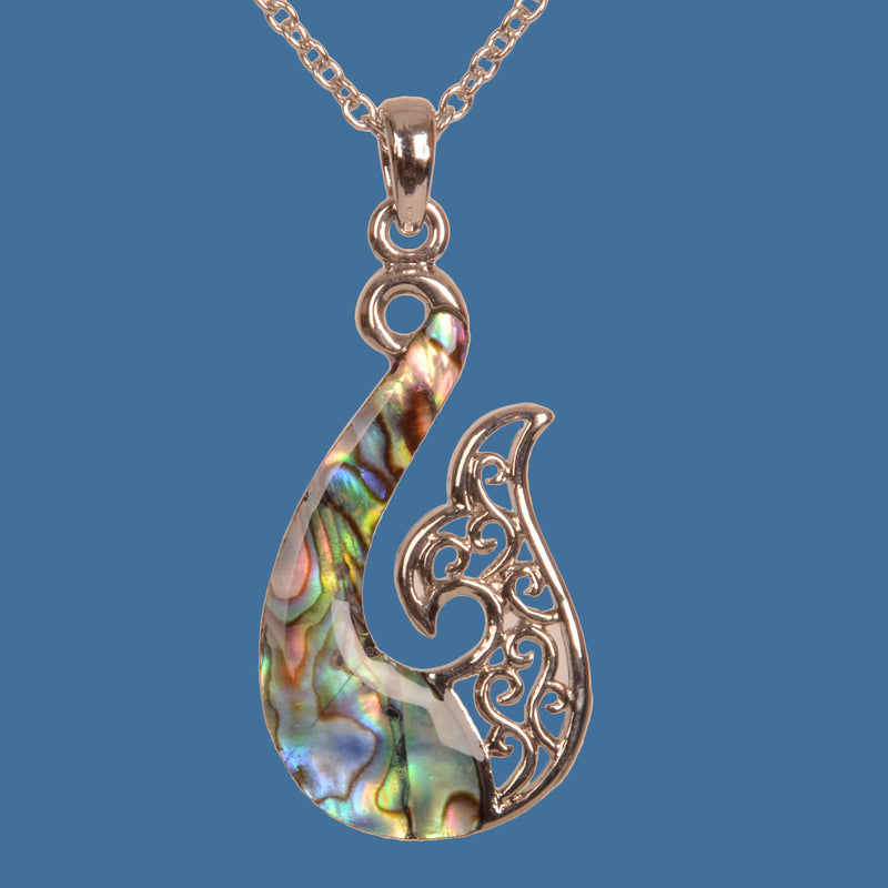 Pendant necklace with intricate design on a blue background