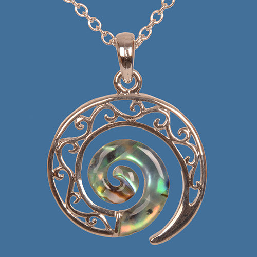 Silver koru pendant on a blue background