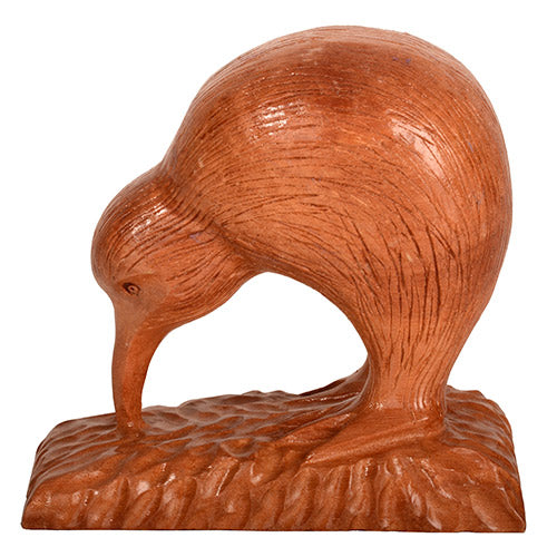 Wooden sculpture of a kiwi bird on a white background