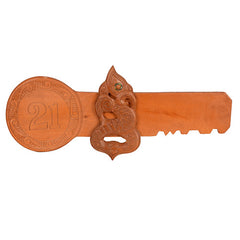 Wooden key with decorative carvings and number '21' on a white background