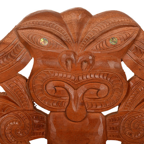 Wooden decorative lintel with intricate carvings on a white background