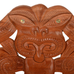 Wooden decorative lintel with intricate carvings on a white background