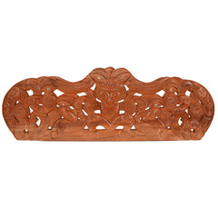 Wooden decorative lintel with intricate carvings on a white background