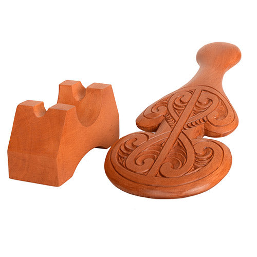 Wooden decorative item with intricate carvings on a white background