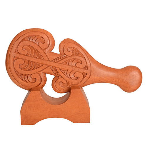 Wooden decorative item with intricate carvings on a white background