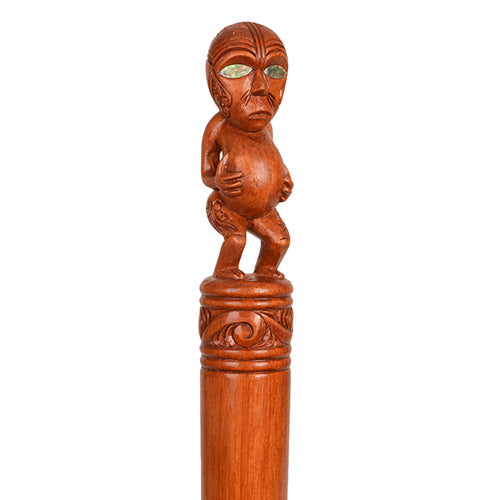 Wooden decorative staff with a carved top on a white background