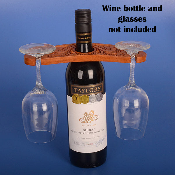 Wooden glass holder with intricate carvings on a white background