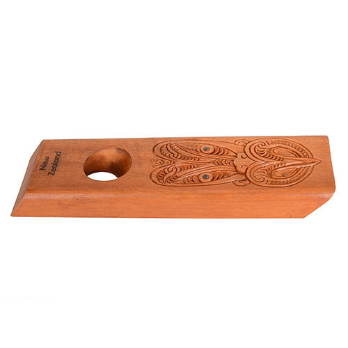 Wooden bottle holder with engraved design on a white background