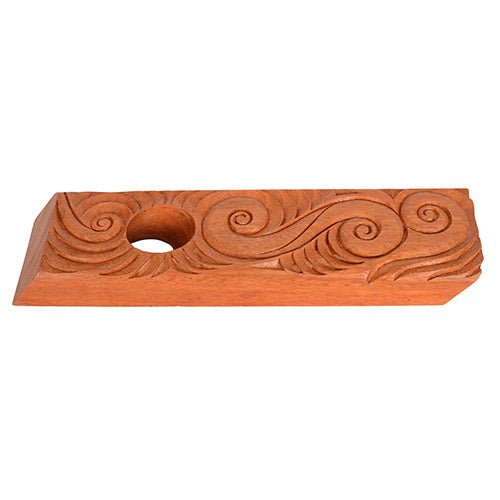 Wooden bottle holder with carvings on a white background