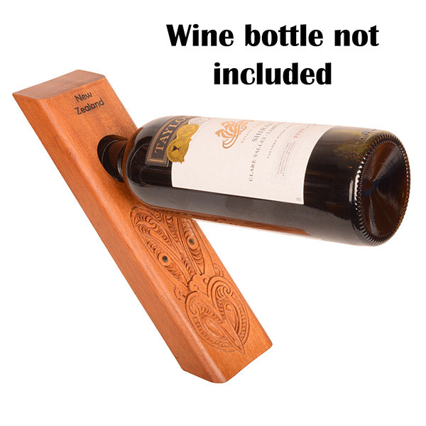 Wooden bottle holder with engraved design on a white background